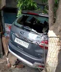 बस्ती बावा खेल के पेस्ट राज नगर चौक में हादसे के बाद क्षतिग्रस्त कार, टूटा पेड़ और मौके पर मौजूद पुलिस व स्थानीय लोग।